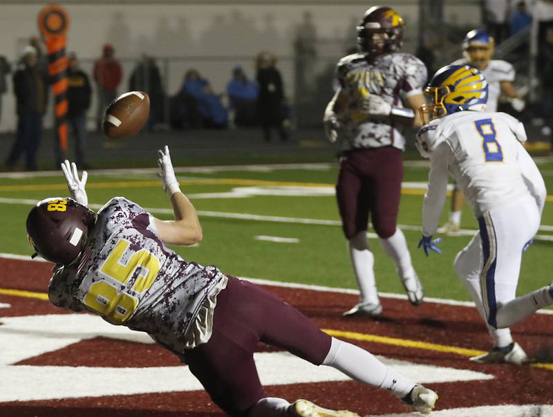 Richmond-Burton's Luke Bresnahan catches the football after it was tipped by Johnsburg's Damin Green in the end zone to score a touchdown during a Kishwaukee River Conference football game Friday, Oct. 7, 2022, between Richmond-Burton and Johnsburg at Richmond-Burton Community High School in Richmond.