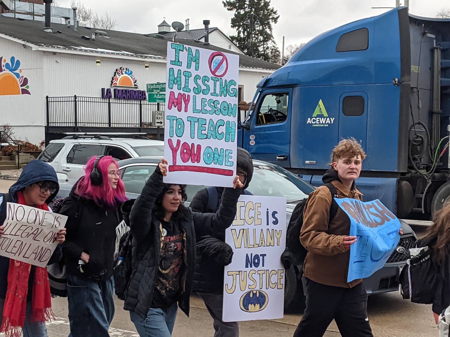 Oswego High School students walk through downtown Oswego as part of a student walkout against the actions of Immigration and Customs Enforcement agents on Friday, Feb. 6, 2026.