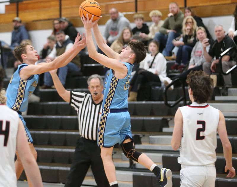 Marquette's Lucas Craig and teammate Griffin Dobberstein grab the ball before it goes out of bounce against Woodland during the Tri-County Conference Tournament on Tuesday, Jan. 28. 2025 at Putnam County High School.