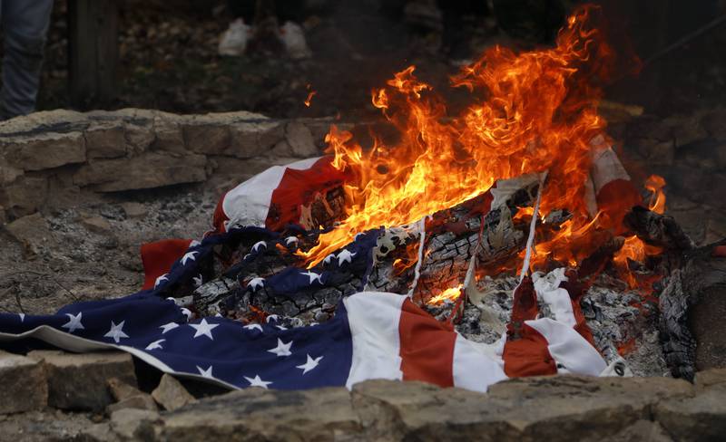 An American flag is retired during the Annual Veterans Day Scout VFW vigil and flag retirement ceremony at Overseas VFW Post 1197 in Batavia on Saturday Nov. 5, 2022.