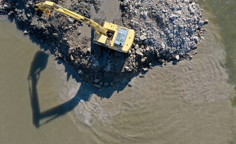 An excavator dredges the harbor at Barto Landing on Wednesday, March 26, 2025 in Spring Valley.