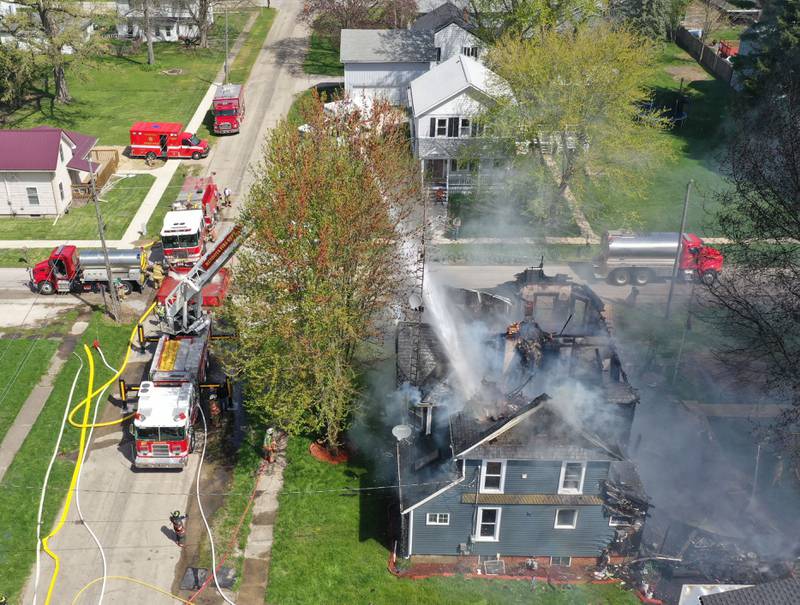 Firefighters from Paw Paw, Somonauk, Troy Grove, Mendota, Earlville, Leland, Utica and Ottawa work the scene of a house fire in the 300 block of Maple Street on Monday, April 22, 2024 in Earlville. The fire happened around 10a.m.