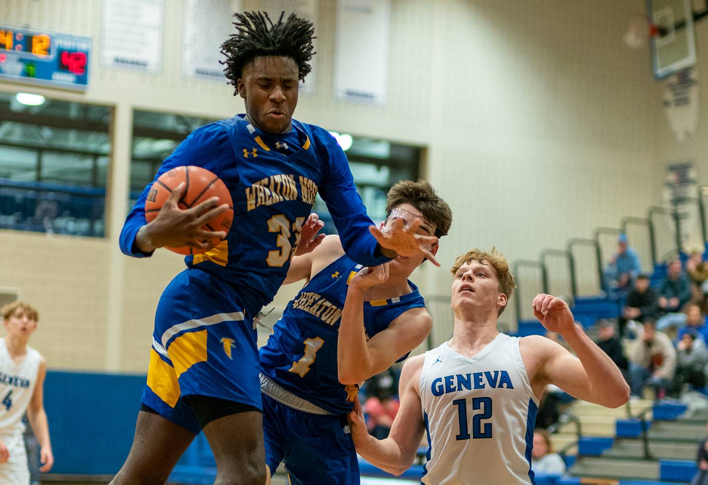 Wheaton North's Jalen Crues (33) rebounds the ball against Geneva during a basketball game at Geneva High School on Friday, Jan 6, 2023.