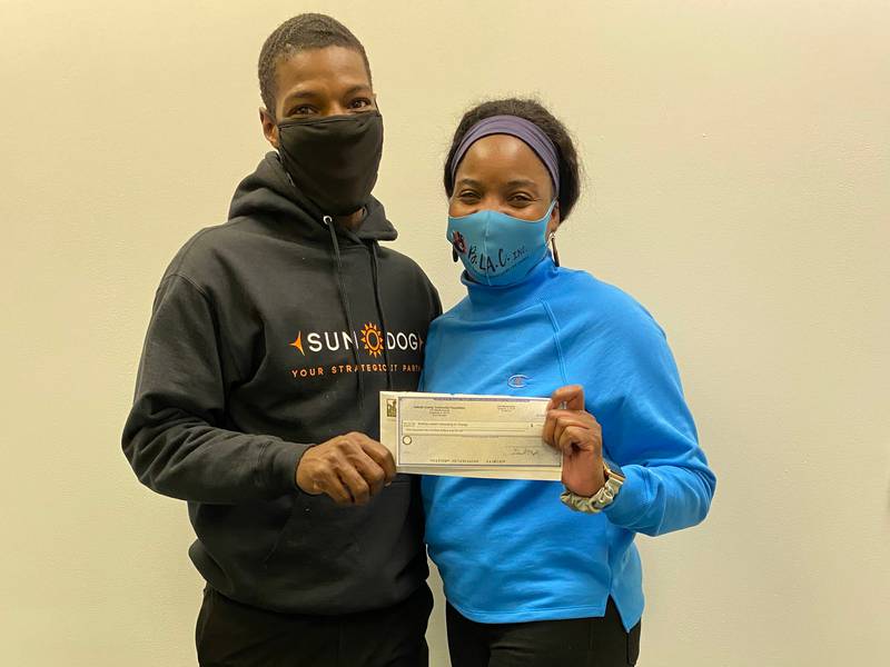 Pictured: Promise Grant Committee member Daveyon Bradley delivering a $1,200 grant check to Tiffany Tucker, Founder and Executive Director of Building Leaders Advocating for Change, Inc. (B.L.A.C.) to provide mental health coaches for teens.
[Image]