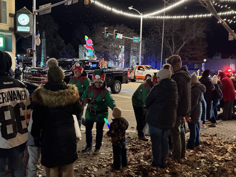 Parade-goers hand out candy during the annual Lighted Holiday Parade on Friday, Nov. 28, 2025.