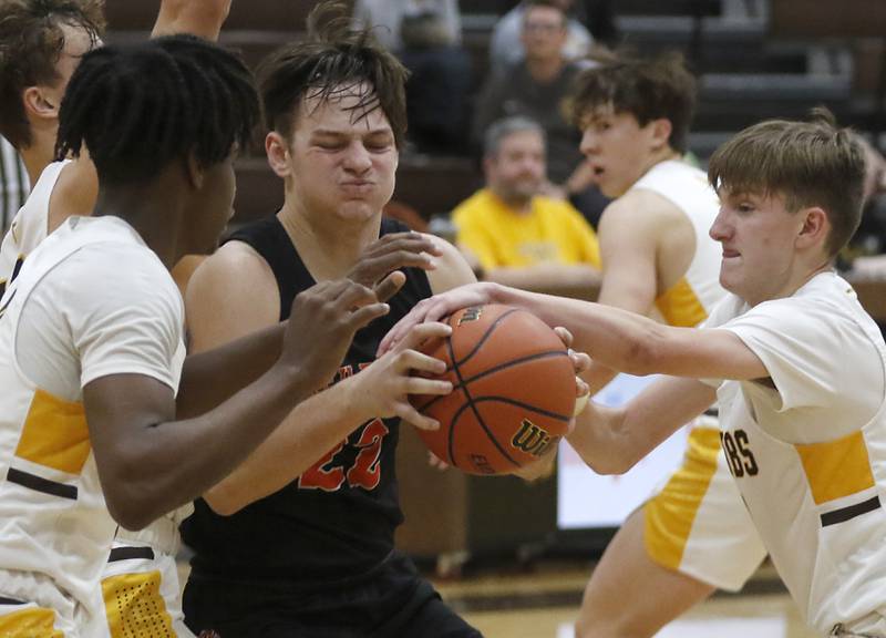 McHenry's Conner McLean looses to the ball as he tries to drive to the basket between Jacobs' Treval Howard, left, and Carter Roper, right, during a Fox Valley Conference basketball game Wednesday, Dec. 7, 2022, between Jacobs and McHenry at Jacobs High School in Algonquin.