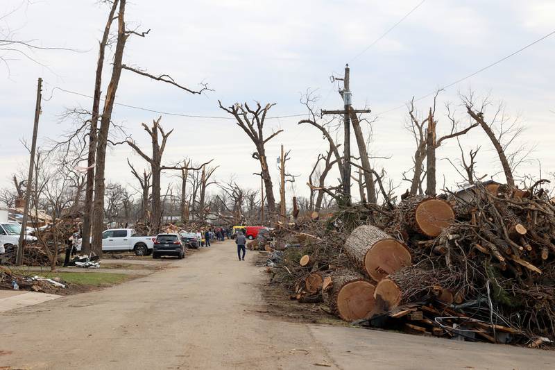 Debris is piled high along Elmwood Drive in Aroma Township on March 14, 2026, as crews worked to clean up following the March 10 tornado in Kankakee County.