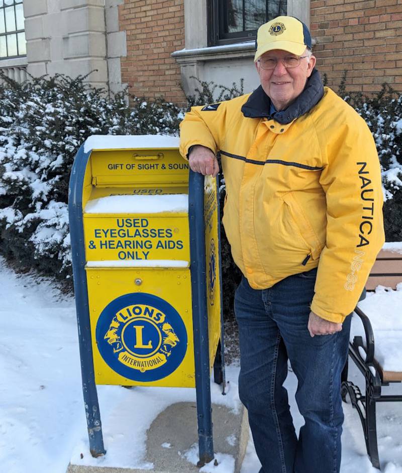 David Burdelak, a member of the Batavia Lions Club stands next to a donation box for used eyeglasses and hearing aids in-front of the Batavia Chamber of Commerce, 106 W. Wilson Street, Batavia.