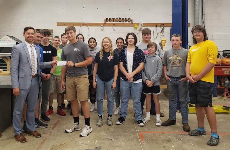 In memory of Burdette Boers, Superintendent Clayton Theisinger presented a check for $500 to Agriculture Construction students at Putnam County High School.