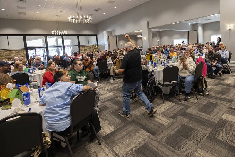 With fist in the air, Danny Holman celebrates his Doris Hammett Positive Attitude Award Thursday, Oct. 17, 2024, at the Self Help client awards banquet.