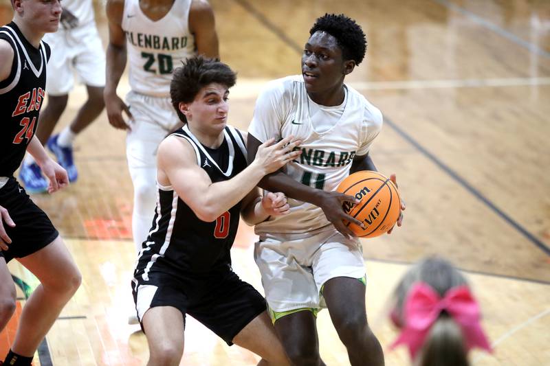 Glenbard West's Teyion Oriental looks for an opening past Glenbard East's Muhammed Musleh during a Class 4A St. Charles East Sectional semifinal against Glenbard East on Tuesday, March 4, 2025 in St. Charles.