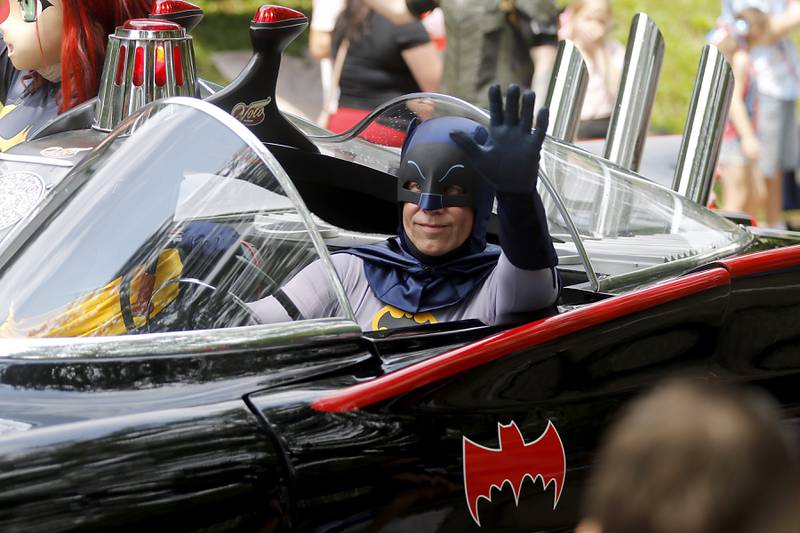 Batman from the Volo Musuem, waves to the crowd from the Batmoblie on Sunday, July 7, 2024, during Crystal Lake’s annual Independence Day Parade on Dole Avenue in Crystal Lake. This year’s parade feature close to 100 units.