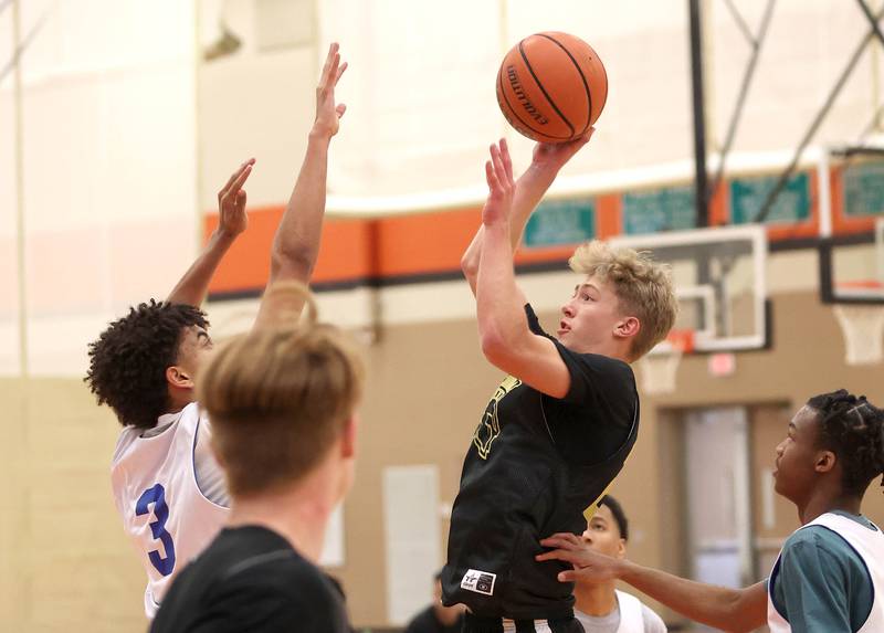 Sycamore's Carter York shoots over a defender during their game with Rockford Christian Tuesday, June 6, 2022, in a summer tournament at DeKalb High School.