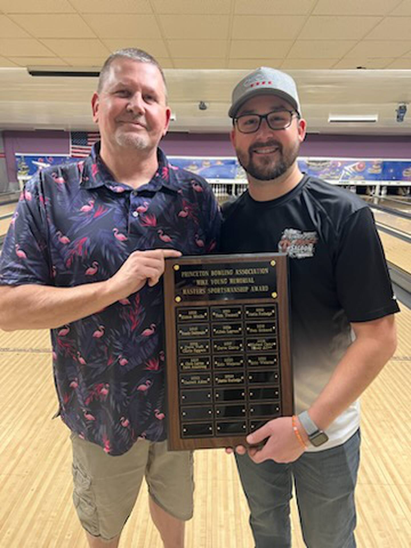 Randy Allen (left), president of the Princeton Men's Bowling Association, presents the Mike Young Sportsmanship Award to Eric Webster.