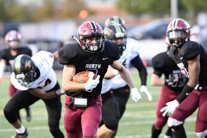 Plainfield North's Nathan Simpson carries the ball through Plainfield East's defense Friday, at Plainfield North High School in Plainfield.