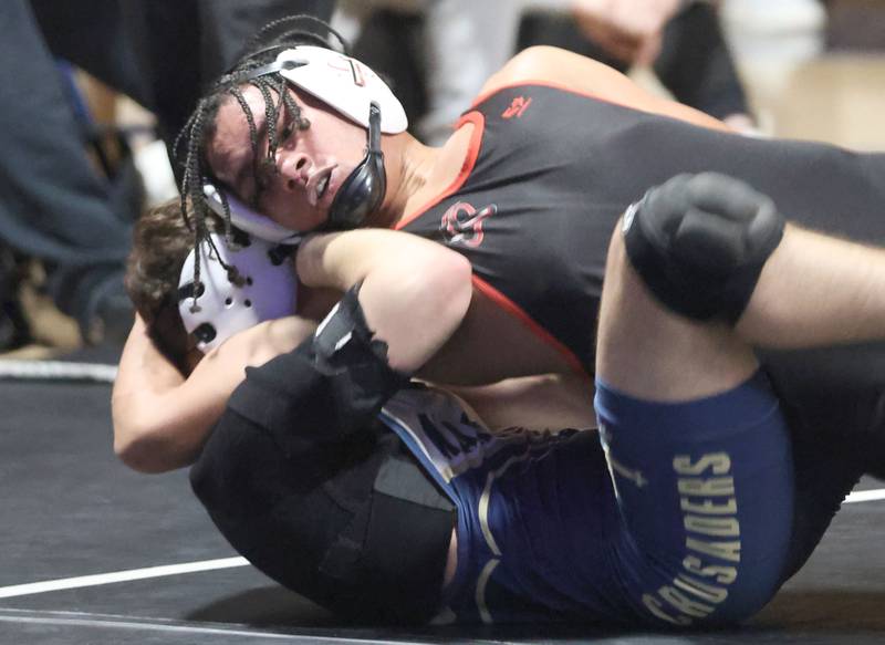 Bradley-Bourbonnias's Jayden Cooper wrestles Marquette's Baeu Thompson on Wednesday, Jan. 14, 2026 in Bader Gymnasium at Marquette Academy.