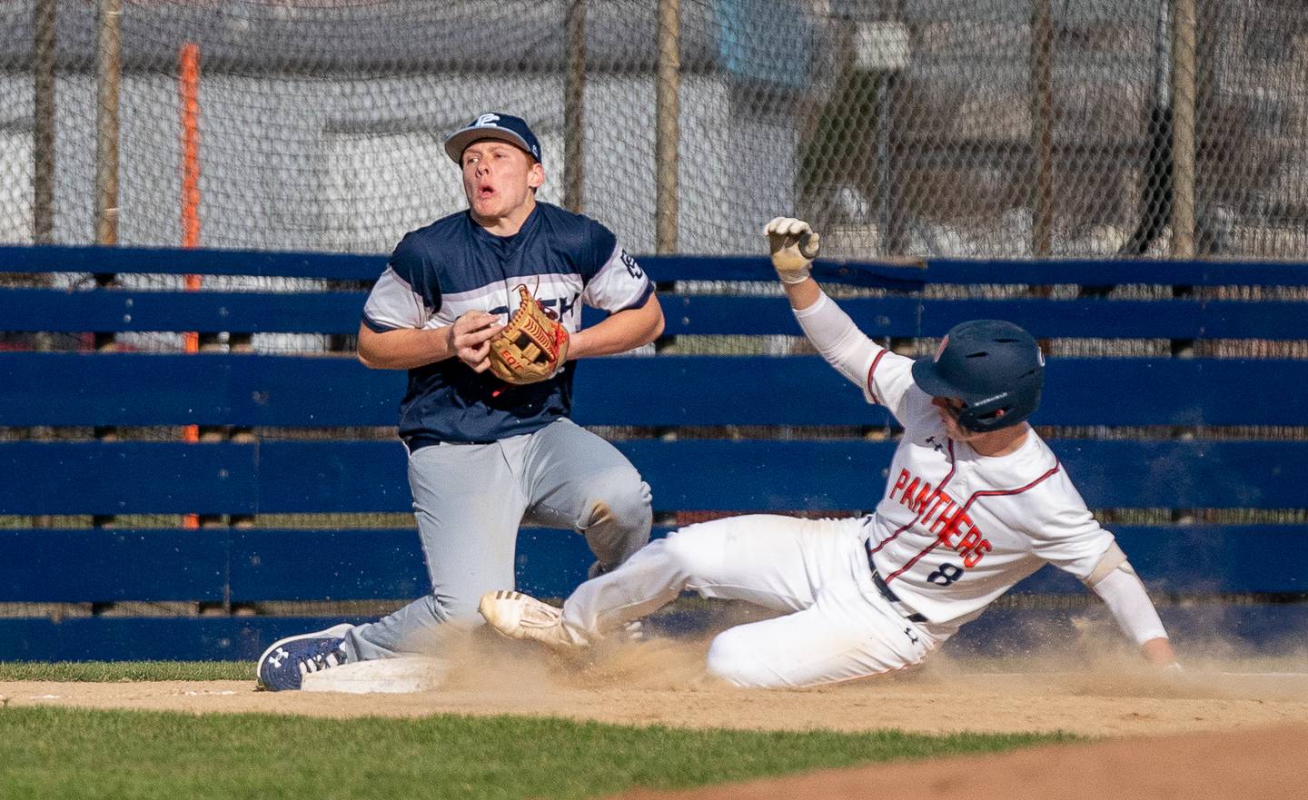 Oswego’s Will Pavlick (8) slides into third base against Plainfield South during a baseball game at Oswego High School on Monday, April 11, 2022.