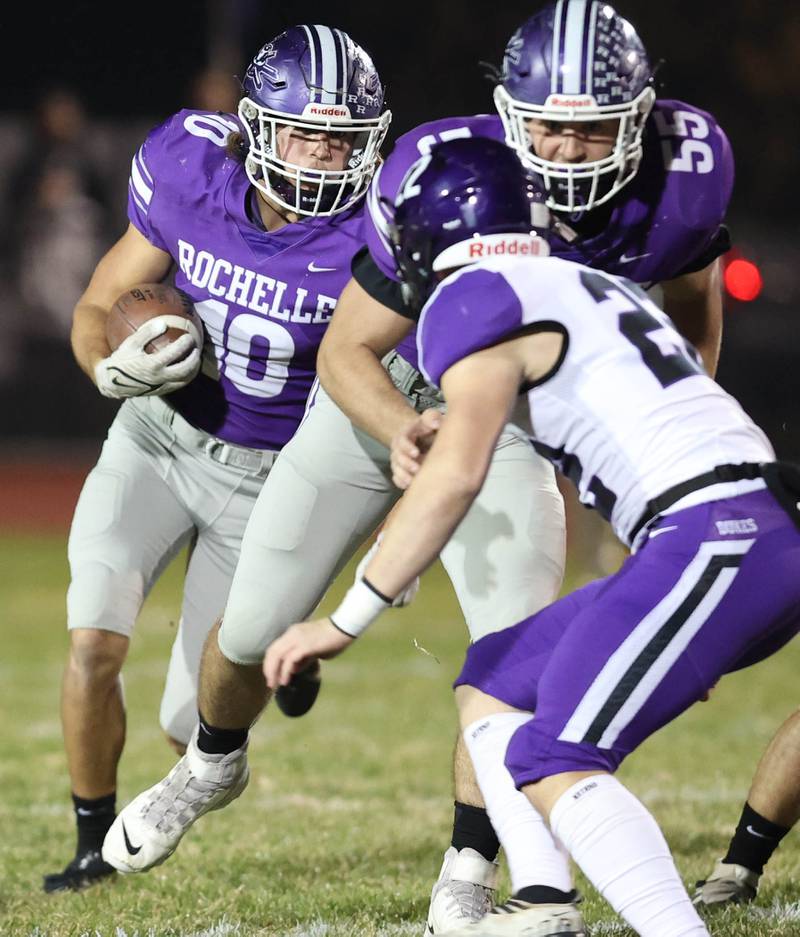 Rochelle's Garrett Gensler tries to get outside of the Dixon defense during their first round playoff game Friday, Oct. 28, 2022, at Rochelle High School.