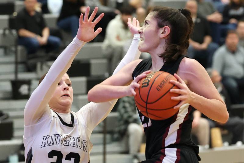 Prairie Ridge's Addie Meyer goes to the basket against Kaneland's Kendra Brown Thursday, Feb 15, 2024, during their Class 3A regional final game at Kaneland High School in Maple Park.