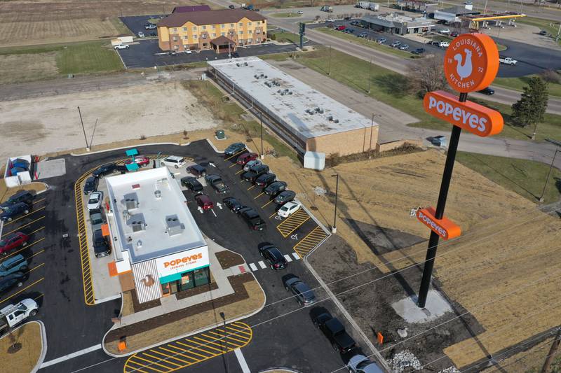 A long line of vehicles is backed up onto May Road for the opening of Popeyes on Monday, Dec. 9, 2024. The franchise opened their doors on Friday.