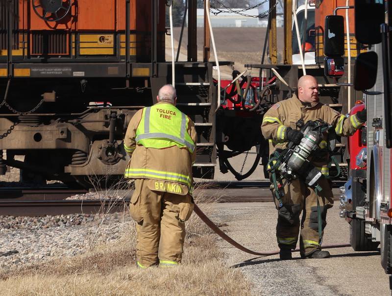 Toluca-Rutland firefighters wind up hoses as they begin to depart the scene of a BNSF locomotive that was leaking fuel near the intersection of 2900 East Street and 500 North Avenue on Wednesday, Feb. 18, 2026 near Toluca. A Mutual Aid Box Alarm System (MABAS) call was sent out shortly after 1p.m but canceled.