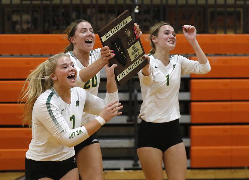 Crystal Lake South's Laken Lepage, Morgan Johnson, and Olivia Apt celebrate defeating Crystal Lake Central in the IHSA Class 3A Crystal Lake Central Regional volleyball final on Oct. 31, 2024, at Crystal Lake Central High School.