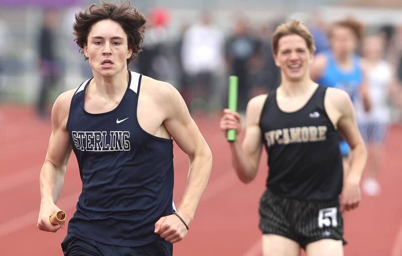 Sterling's Jordan Britt wins the 4x800 meter relay with his team just ahead of Sycamore's Caden Emmert and his team Wednesday, May 18, 2022, at the Class 2A boys track sectional at Rochelle High School.