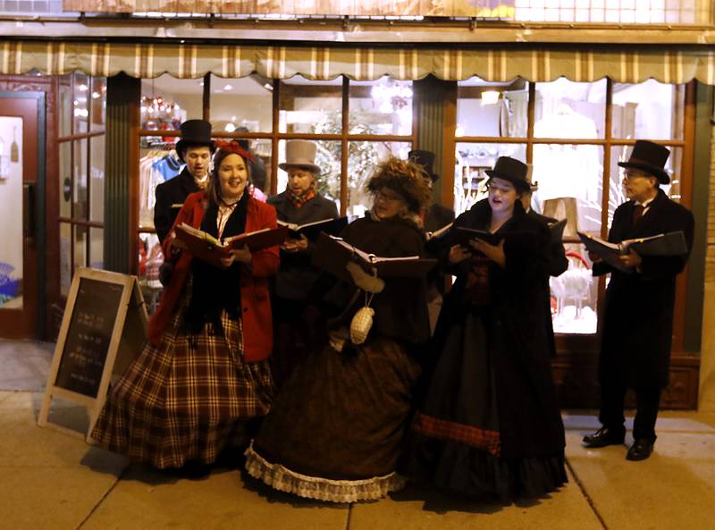 The Dickens Carollers sing during the Lighting of the Square Friday, Nov. 24, 2023, in Woodstock. The annual holiday season event featured brass music, caroling, free doughnuts and cider, food trucks, festive selfie stations and shopping.