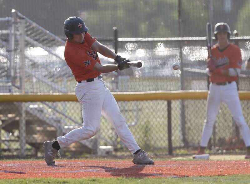 St. Charles East's Mac Paul (14) makes contact during the Class 4A York regional semi-final between Wheaton Warrenville South and St. Charles East in Elmhurst on Thursday, May 23, 2024.
