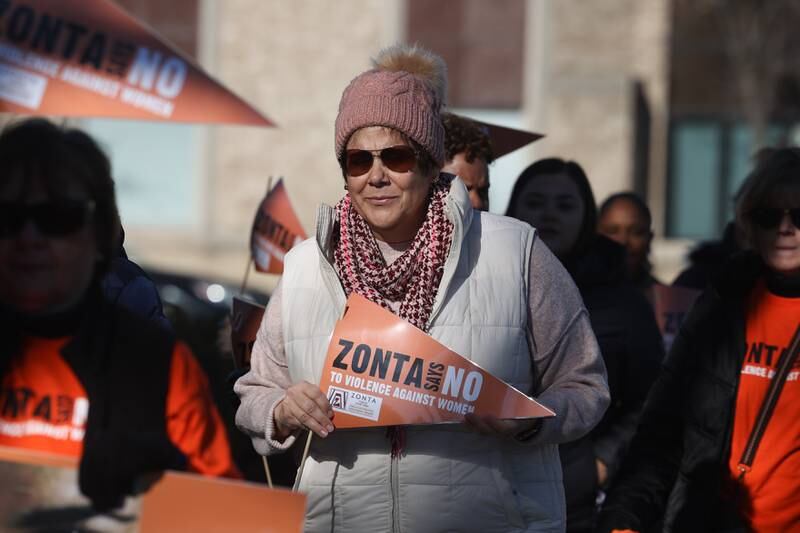 Will County Executive Jennifer Bertino-Tarrant joins the march along Chicago Street during a rally for ZONTA Says No To Violence Against Women on Tuesday in Joliet.