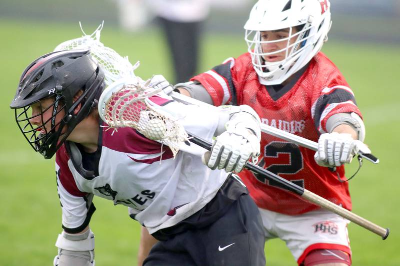 Huntley’s Adrian Passarelli, back, defends as a Prairie Ridge ballcarrier advances in varsity boys lacrosse at Prairie Ridge  High School in Crystal Lake on Thursday, May 1, 2025.