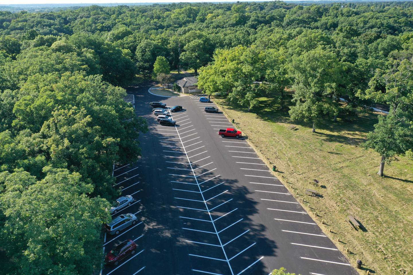 Vehicles park in a newly paved parking lot at Matthiessen State Park on Tuesday, Aug. 16, 2022 in Oglesby. Crews paved the parking lot and entrance road to Illinois Route 178. A sidewalk was also added along the entrance road.