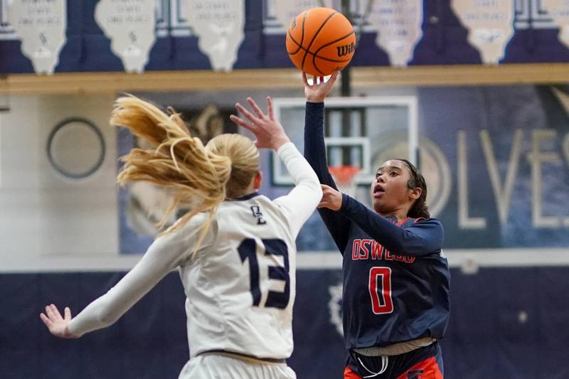 Oswego’s Ashley Cook (2) shoots the ball over Oswego East's Cassie Van Meter (13) during a basketball game at Oswego East High School on Saturday, January 14, 2017.
