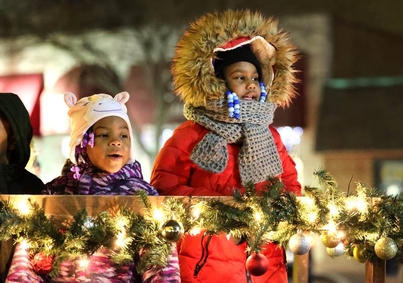 Eyanni Booker, (left) 3, and Faith Williams, 6, from DeKalb, sing carols as they wait for Santa at the Santa house near the Egyptian Theatre Thursday, Dec. 1, 2022, during the DeKalb Chamber of Commerce Lights on Lincoln and Santa Comes to Town.