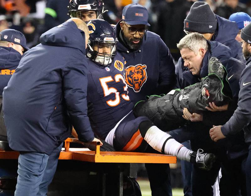 Chicago Bears linebacker T.J. Edwards is helped onto the cart after injuring his left leg during their NFL Wild Card game Saturday, Jan. 10, 2026, at Soldier Field in Chicago.