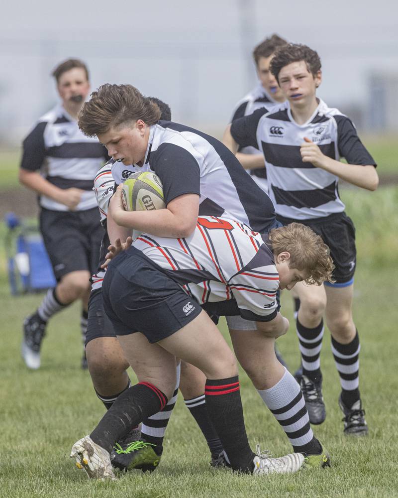 John Stacy of the West Suburban Barbarians drives the ball down the field against the tackle of Dominic Coles of the Stallions Rugby Club during the game at Veterans Park on April 28, 2024.