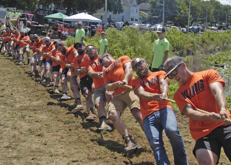 Tuggers from Peacocks Tavern pull hard as part of the Port Byron-hosted Great River Tug Fest across the Mississippi River on Saturday, Aug. 10, 2024.