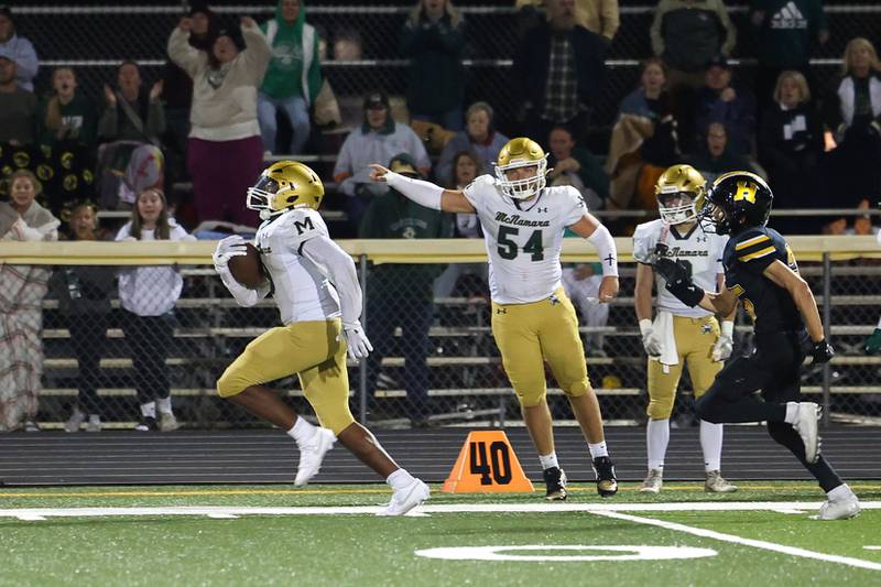Bishop McNamara's Julius May breaks away from Herscher defenders for an 87-yard touchdown to secure a 38-28 lead near the end of the fourth quarter during the Fightin' Irish's 45-28 victory over Herscher on Friday, Sept. 5, 2025.