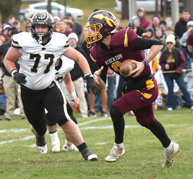 Stockton quarterback Noah Larson runs with the ball against Lena-Winslow in 1A semifinal action in Stockton on Saturday, Nov. 22, 2025.