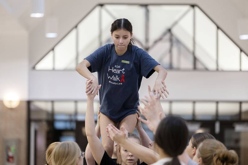 Nevaeh McElhiney prepares for a stunt while practicing Wednesday, Jan. 18, 2023 at Erie High School for the IHSA competitive cheerleading sectional, which will be Saturday at Belvidere North High School.