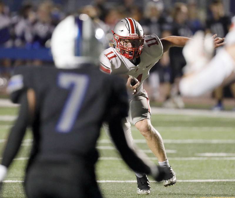 Palatine's Trey Widlowski (11) looks for an opening Friday August 25, 2023 in St. Charles.