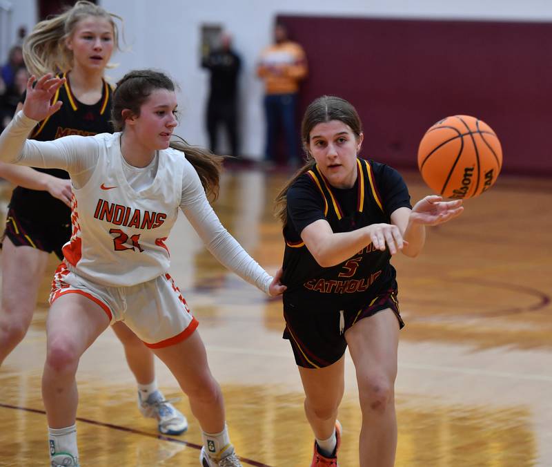 Montini’s Kaelyn Zumdahl passes the ball as Minooka’s Sadie Webb (21) defends during a Montini Christmas Tournament game on December 22, 2025 at Montini Catholic High School in Lombard.