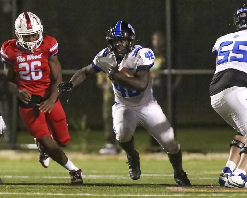 St. Francis's Tivias Caldwell (42) runs up the middle during football game between St. Francis at Kenwood Academy on Thursday, Aug 28, 2025  in Chicago.