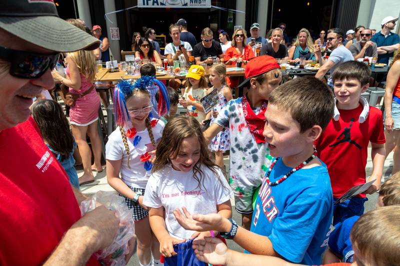 Kids receive candy on Main Street during Glen Ellyn’s “4th of July Parade” on Friday, July 4, 2025.