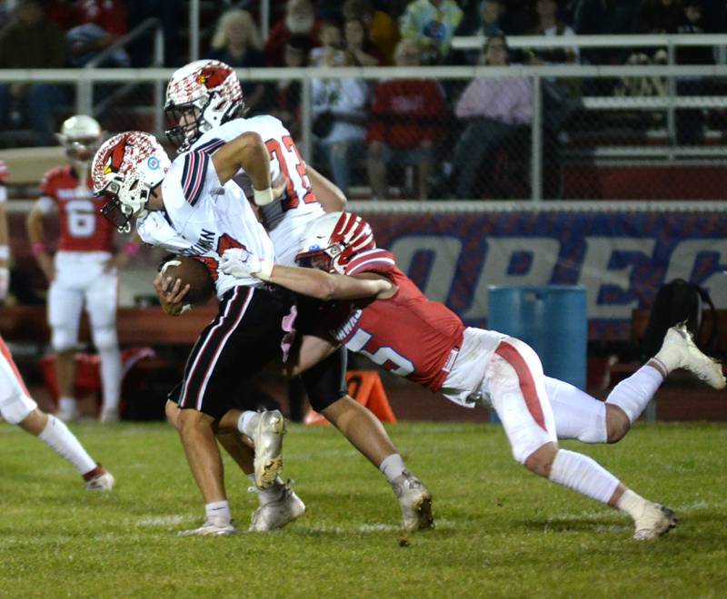 Oregon's Hunter Bartel  (5) hangs on to Stillman Valley's Michael Orlando (33) on Friday, Oct. 4, 2024 at Landers-Loomis Field in Oregon.