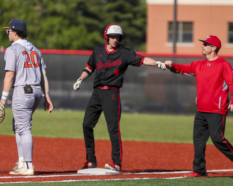 Yorkville's Kamden Muell (9) is greeted at first during baseball game between Oswego at Yorkville. Thursday, May 8, 2025 in Yorkville.