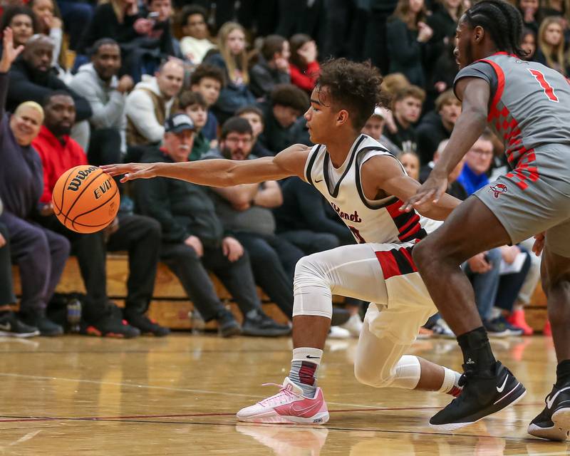Benet's Blake Fagbemi (0) handles the ball against the defense during their When Sides Collide Shootout basketball tournament matchup between Rich Township at Benet Academy. Jan 25, 2025 in Lisle.
