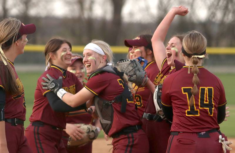 Richmond-Burton’s Rockets are aglow after an extra-inning win in varsity softball at Marengo Wednesday evening.