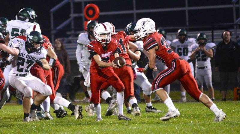 Forreston quaretrback Brady Gill hands the ball to Owen Mulder during Friday, Sept. 22, 2023 action against West Carroll at Forreston High School.