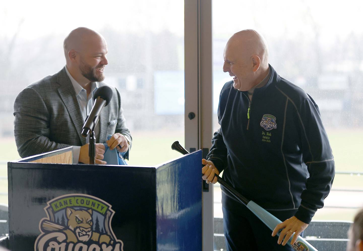 Former Kane County Cougars owner Bob Froehlich, right, shares a laugh with President of REV Entertainment Sean Decker before Rev Entertainment announced they are the new owners of the Kane County Cougars during a press conference Wednesday, April 2, 2025 at Northwestern Medicine Field in Geneva Ill.